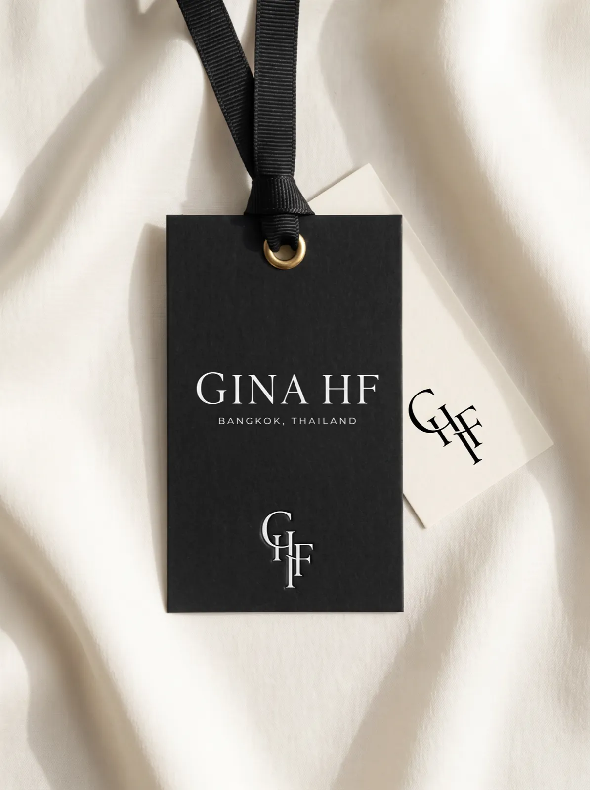 The hangtag of the house on ivory silk — Nocturne editorial